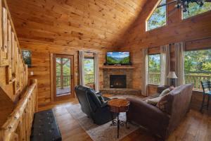 a living room with a fireplace in a log cabin at Wilderness Lodge, Hot Tub, Pool Table, Pool Access, WIFIeach paid day in Sevierville
