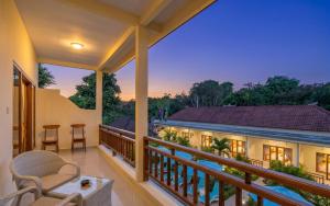 a balcony with a view of a house at Bali Nusa Cottage in Nusa Lembongan