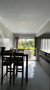 a dining room with a table and some chairs at cabana refúgio in Paulo Lopes