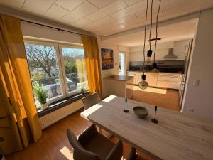 a kitchen and dining room with a table and a window at Chalet Annemie in Mendig