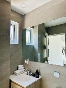 a bathroom with a sink and a mirror at The Views Resort in El Zonte +85 photos