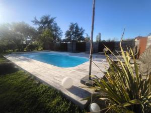 a swimming pool in a yard with a wooden deck at Studio meublé Rosieres in Rosières