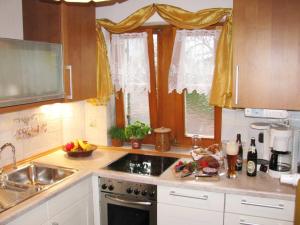 a kitchen with a sink and a stove top oven at Ferienwohnung HERZOGSTAND in Krün