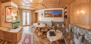 a living room with a couch and a tv at Ferienwohnung KARWENDEL in Krün