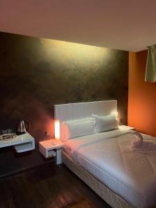 a bedroom with a bed and a painting on the wall at BlackView in Kota Kinabalu
