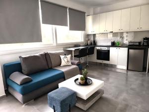 a living room with a couch and a table at Basil Leaf - Minimal View Retreat in Gonia
