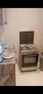 a kitchen with a stove top oven in a kitchen at ريم الفلا in Dawwār Abū Maḩrūs