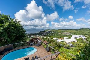 a swimming pool on a deck with a view of the ocean at 2-3 personnes - Vue Mer et Piscine - Anse à l Âne - trois Îlets - Plage 2 min en voiture in Les Trois-Îlets