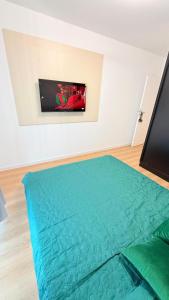 a bed in a room with a television on a wall at TRIO Sun Class Park Residence in Târgovişte