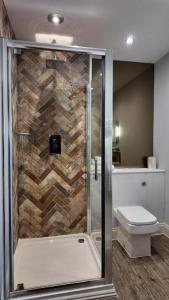 a bathroom with a shower and a toilet at The Gregory Arms in Harlaxton