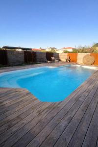 a swimming pool on a wooden deck at Studio meublé Rosieres in Rosières +2 photos