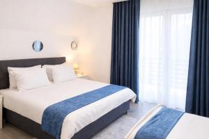 a hotel room with two beds and a window at Ćato s cottage in Bravnice