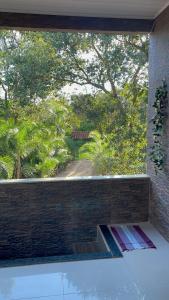 a window with a view of a road outside at Recanto Chaparral in Aragoiânia