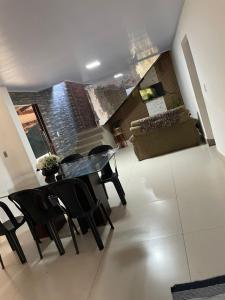 a view of a living room with a table and chairs at Recanto Chaparral in Aragoiânia