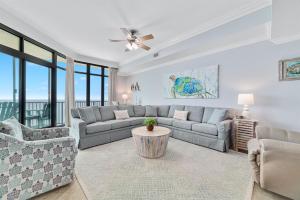 a living room with a couch and a table at Phoenix West 2207 Upscale Luxury Updated Beachfront Waterslide-Lazy River in Orange Beach