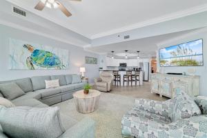 a living room with a couch and a table at Phoenix West 2207 Upscale Luxury Updated Beachfront Waterslide-Lazy River in Orange Beach