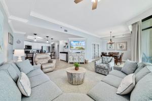 a living room with a couch and a table at Phoenix West 2207 Upscale Luxury Updated Beachfront Waterslide-Lazy River in Orange Beach +57 photos