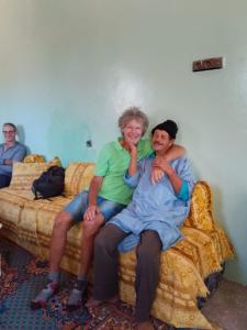 a couple of people sitting on a bed at اميزميز in Amizmiz