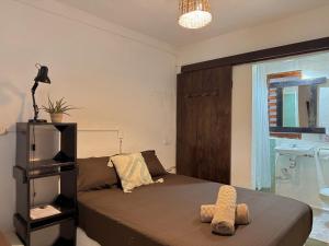 a bedroom with a bed with two towels on it at Casa OMI in Brisas de Zicatela +114 photos