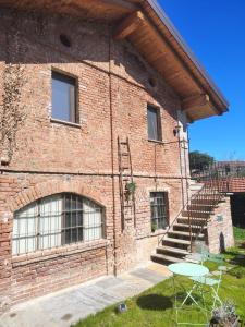 ein Backsteingebäude mit einer Treppe und einem Tisch in der Unterkunft CaDiMon in Cuneo + 7 Fotos