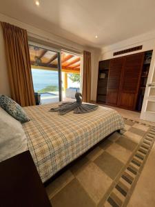 a bedroom with a bed with a view of the ocean at Ballena Bay Villa Lot 45 Villa del Mar in Tambor