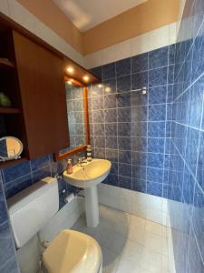 a bathroom with a white toilet and a sink at Orizzonte guest house in Laigueglia