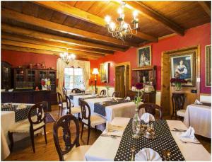 a restaurant with tables and chairs in a room at De Ark Guest House in Lydenburg
