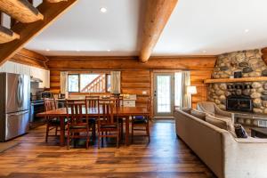 a kitchen and dining room with a table and chairs at Mike Wiegele Helicopter Skiing in Blue River