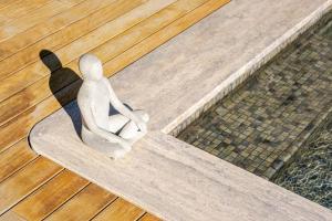 a statue of a person sitting on a bench at Luxurious Villa Private Pool Private Beach Views in Bodrum City
