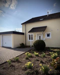 a house with a garage and a driveway at Ferienhaus Eiforia in Gerolstein