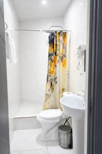 a bathroom with a toilet and a sink and a shower at Backpackers Tashkent in Tashkent