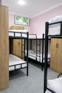 a room with several bunk beds in it at Backpackers Tashkent in Tashkent +13 photos