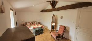 a bedroom with two beds and a table and chairs at rêve d'escapade in Mouilleron-en-Pareds
