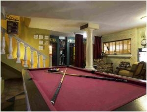 a pool table in a living room with a bill at De Ark Guest House in Lydenburg