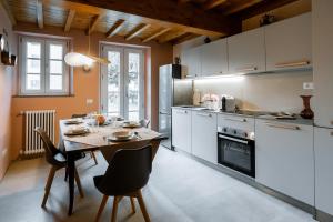 a kitchen with a table and a dining room at L'oasi di Renata in Lammari