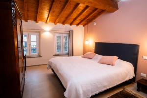 a bedroom with a large white bed with two pillows at L'oasi di Renata in Lammari
