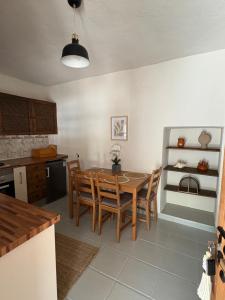 a kitchen with a dining room table and chairs at Finca Los Arcos Bed and Breakfast Comares Malaga in Comares