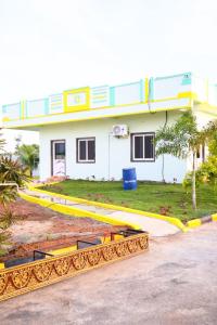 a house with yellow barriers in front of it at MMG Resorts in Nāspur