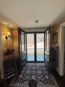 a hallway with an open door with a view of a pool at Ballard House Inn in Meredith