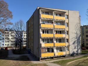 an apartment building with yellow balconies in a city at Ostoja Apartament Bytom Miechowice 24H - blisko A1, Gliwice 15 min in Bytom