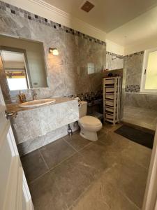 a bathroom with a toilet and a sink and a tub at Ballena Bay Villa Lot 45 Villa del Mar in Tambor +62 photos
