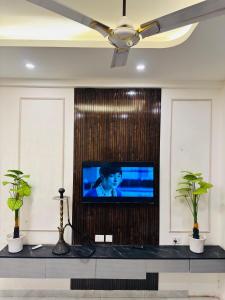 a living room with a tv on a wall at The Skyline Studios in Ghaziabad
