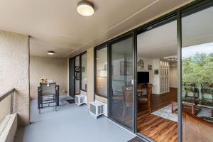 a room with glass doors and a living room at Kona Pacific E629: Beautifully Remodeled condo! in Kailua-Kona