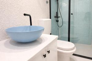 a bathroom with a blue bowl sink on a counter at Apartments FLORA and boat cruising in Virpazar +32 photos