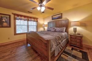 a bedroom with a bed and a ceiling fan at Break Time in Gatlinburg +55 photos