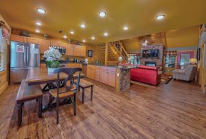 a large kitchen with a table and a refrigerator at Break Time in Gatlinburg