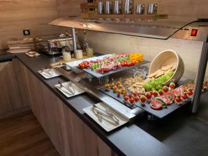 a buffet with fruits and vegetables on a table at Penzion U Růže in Sezimovo Ústí