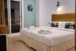 a bedroom with a large bed with towels on it at Hotel Molí Beach in Benidorm