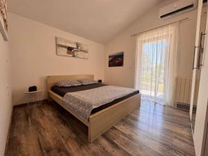 a bedroom with a bed and a large window at Apartment olive tree garden&poll view 4 plus 2, 130 m2 with tiki bar in Peroj +73 photos