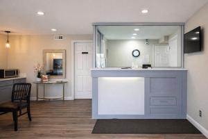 a kitchen and living room with a counter and a table at Quarters Inn & Suites in Antioch